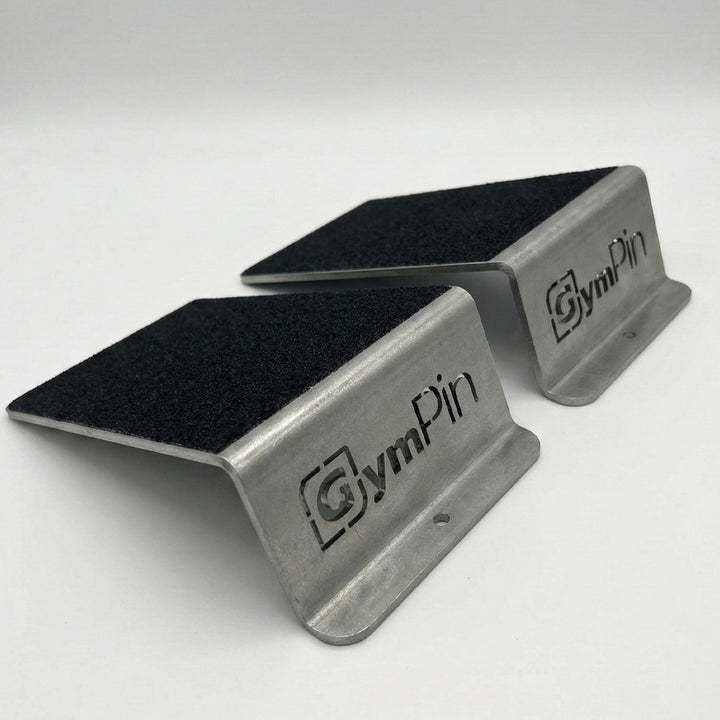 GymPin Steel Squat Wedges with grip tape. Professional grade heel ramps for squats and calf raises, featuring laser-cut branding and durable metal construction.