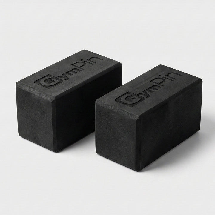 Pair of GymPin Starting Blocks made from dense black foam with embossed GymPin branding, used to elevate machine start positions and improve range of motion during training.